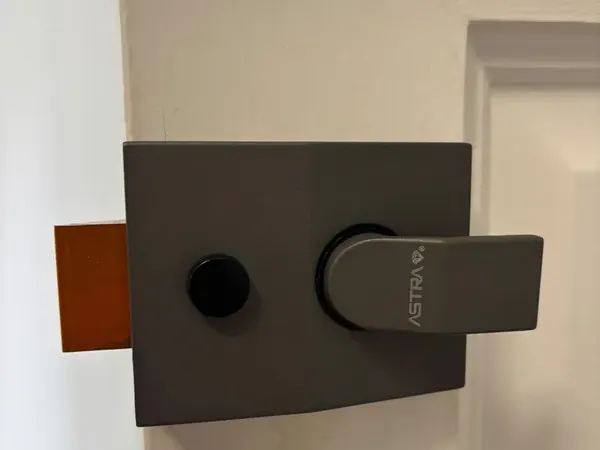 Grey nightlatch fitted to the inside of a front door