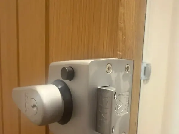 British Standard nightlatch with locking knob on an oak door